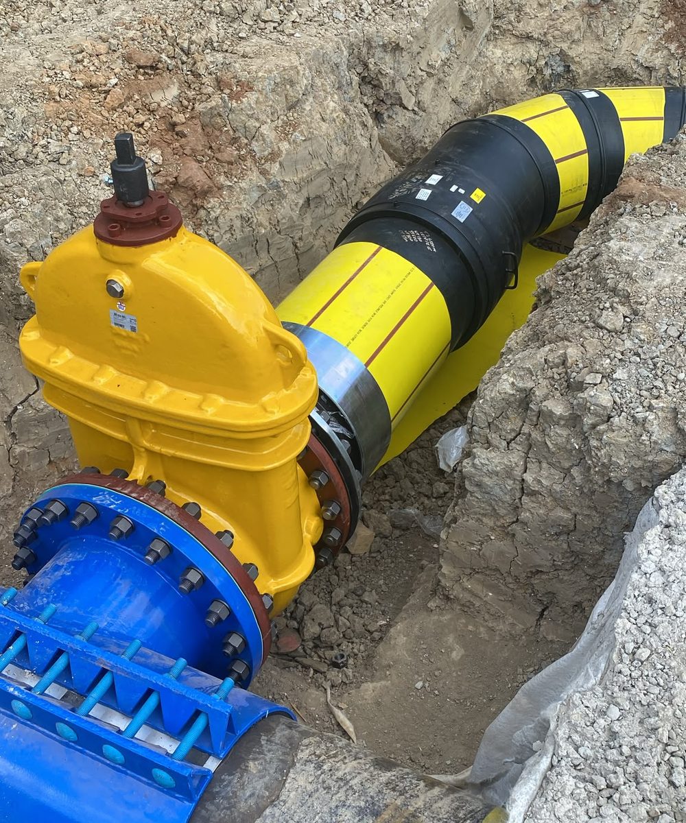 New gas valve and flange assembly installed in an open excavation