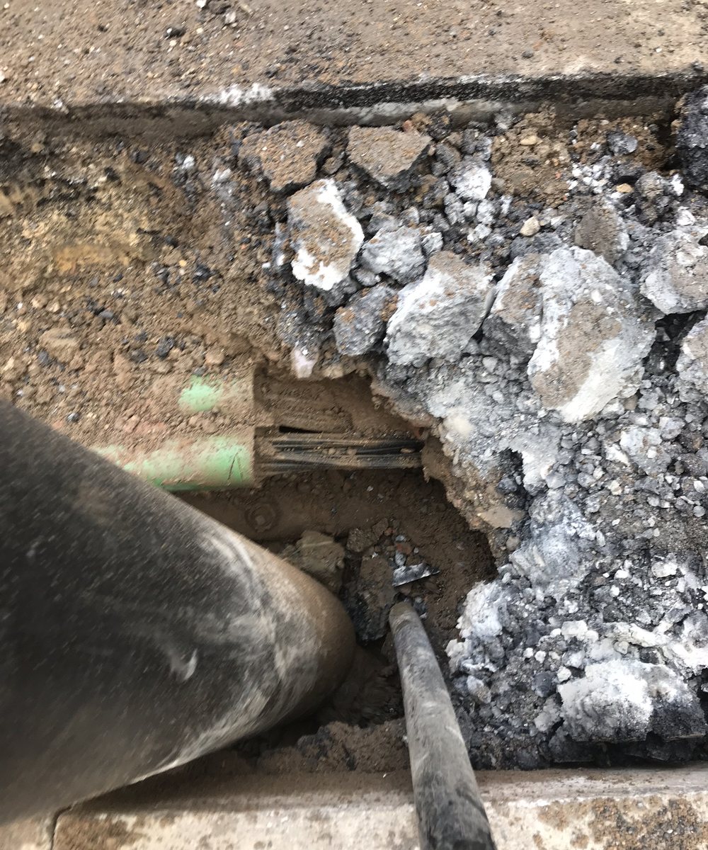 Trial hole vac-dug beside a live gas main, buried services exposed cleanly without a scratch on them