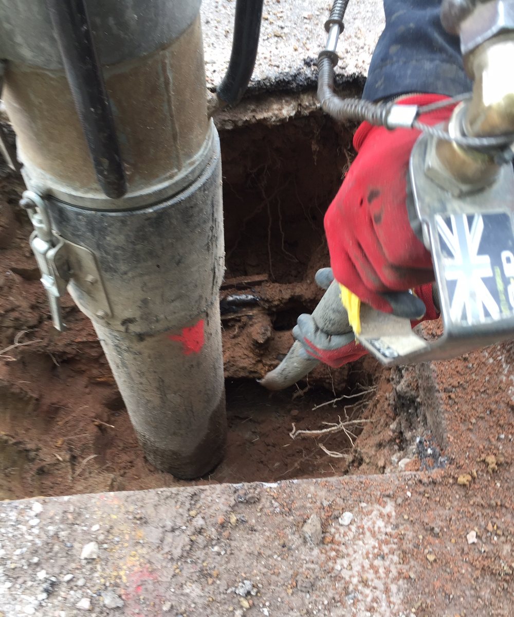 Suction hose working down alongside buried services